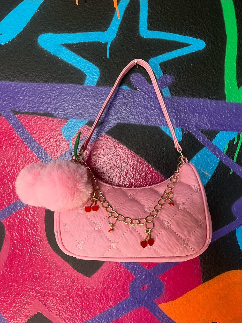 Under One Sky pink quilted handbag with cherry pom pom and bracelet